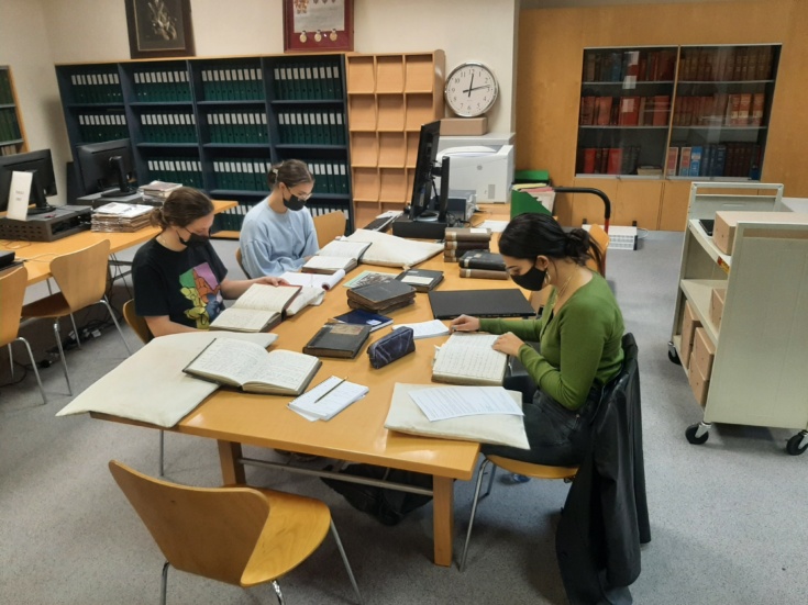 The volunteers researching with local school log books from the 19th and early 20th century. © Newham Heritage Service