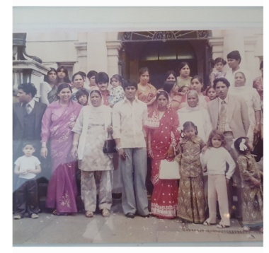 A south Asian wedding party, bride, groom and guests dressed in south Asian wedding clothes.