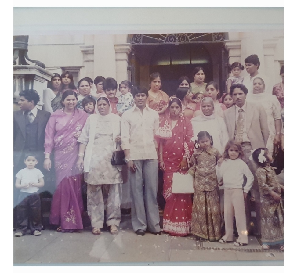 A south Asian wedding party, bride, groom and guests dressed in south Asian wedding clothes.