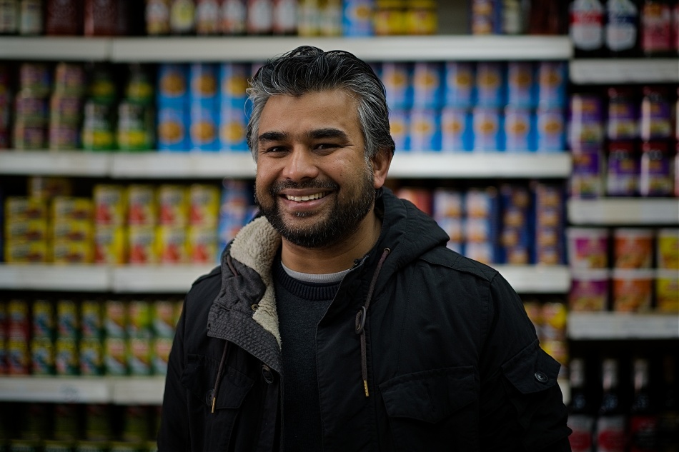 Mohammed, owner of Miah's Oriental Foods (East London) in his shop, © Keith Martin for the Migration Museum