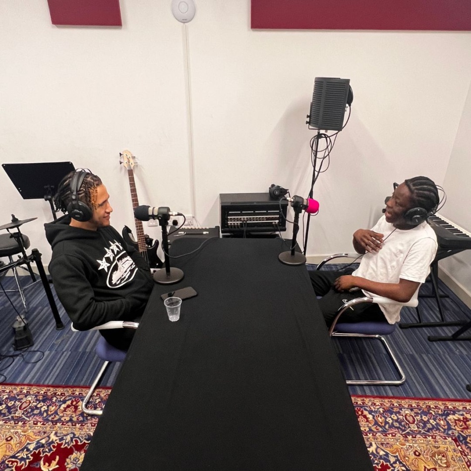 Two people in a podcast Studio
