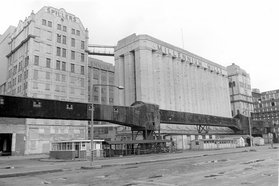 Black and white photo of exterior large factory signed Spillers and Millensium Mill 1984