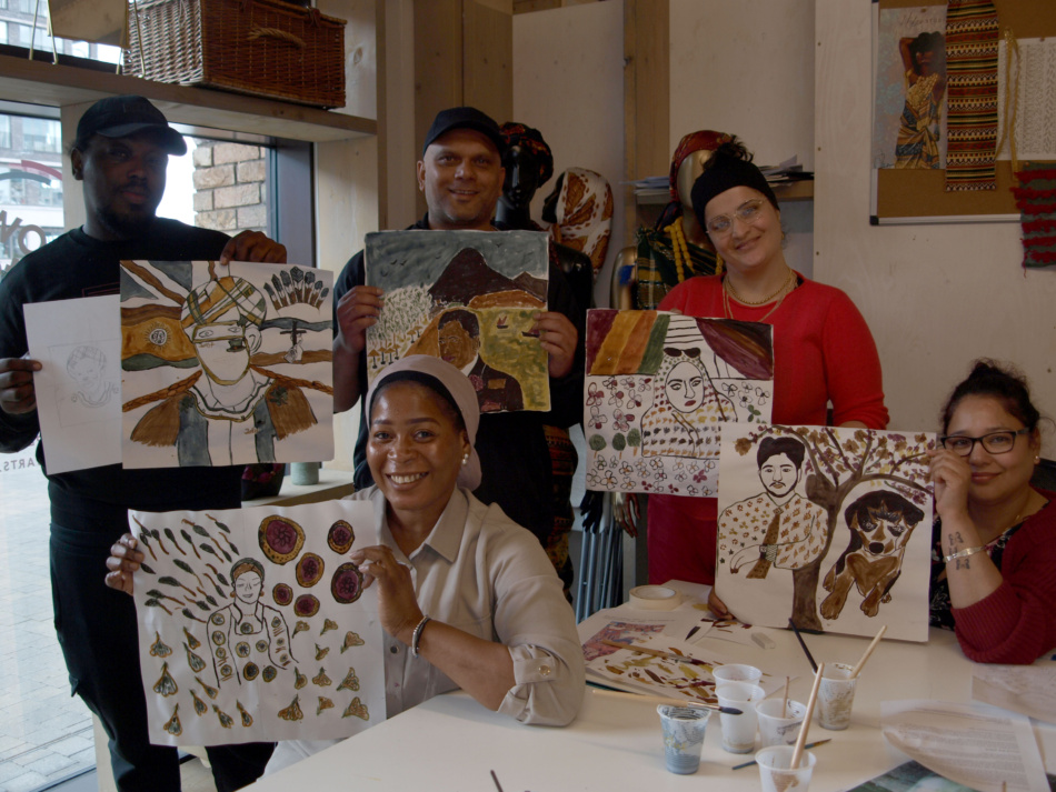 Students holding their artwork