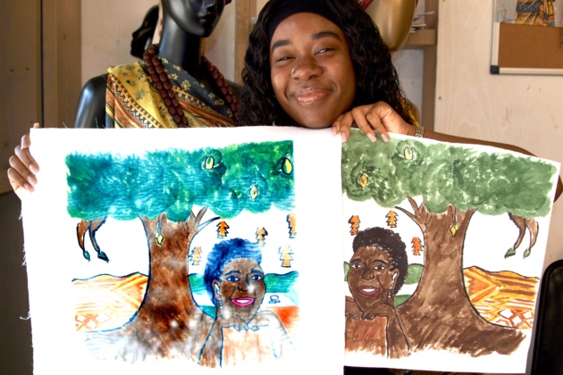 Student holding up final textile print